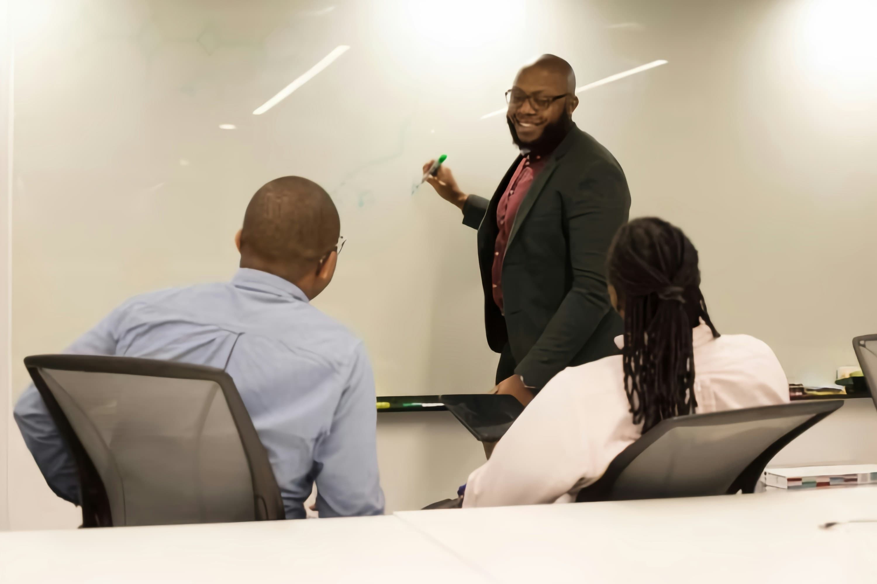 Photo — mentor guiding learners during a Saturday practical session